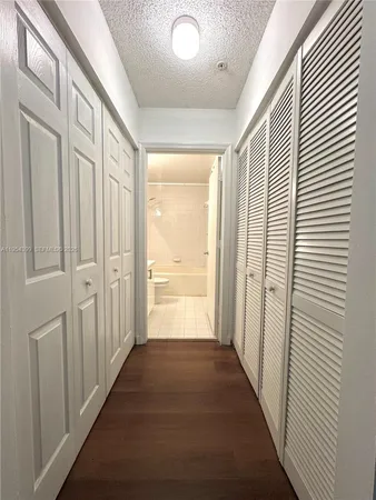 a view of a hallway with a wooden door