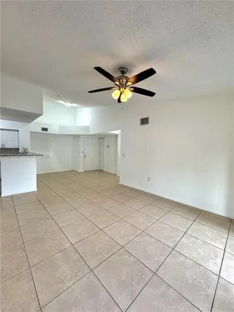a view of a livingroom with a ceiling fan and window