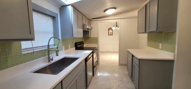 a kitchen with a sink and cabinets