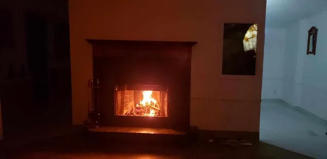a view of a house with large trees and a barn