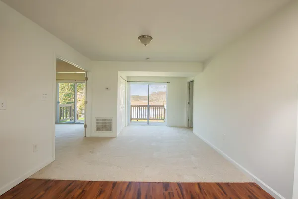 a kitchen with granite countertop wooden floors a stove and a microwave