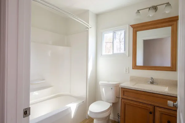 an empty room with closet and a chandelier fan