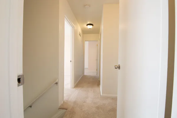 a view of a bathroom from a hallway