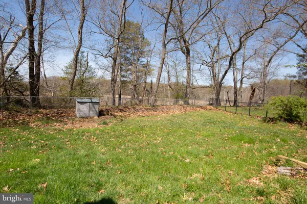 a view of backyard with seating space and trees