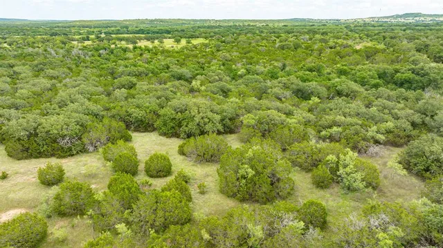a view of a green field with an outdoor space