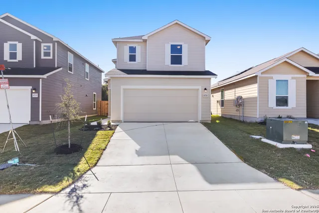 a view of a white house with a yard