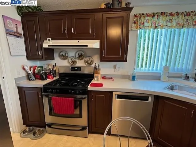 a kitchen with a stove a sink and a microwave