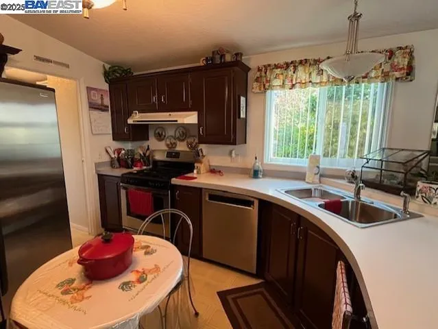 a kitchen with a sink stove and refrigerator