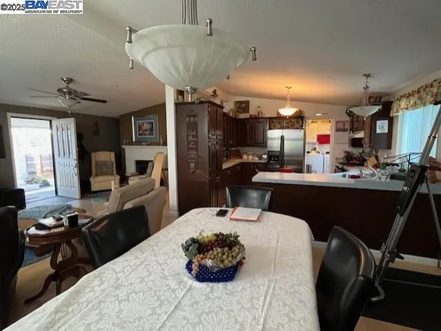 a kitchen with a table chairs and appliances