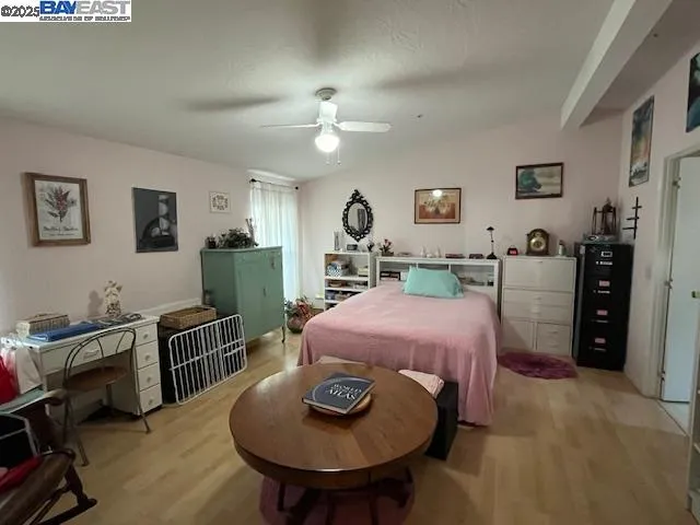 a bed room with furniture and a mirror