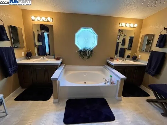 a bathroom with a sink a toilet mirror and vanity
