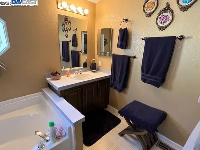 a bathroom with a sink vanity and mirror