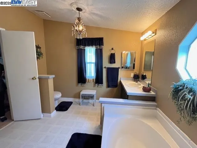 a bathroom with a bathtub sink and a mirror