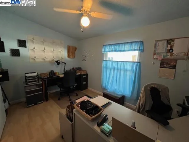 a view of a workspace with furniture and a window