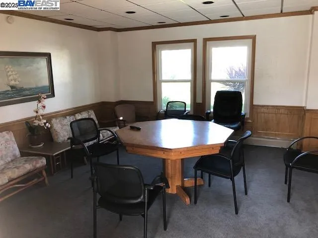 a view of a patio with couches table and chairs and potted plants