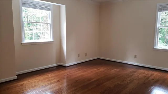 a view of walk in closet with empty racks