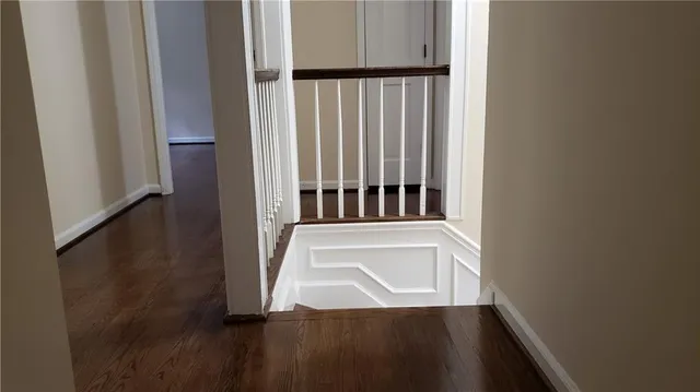 a view of entryway and hall with wooden floor