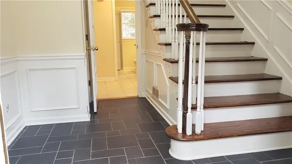 a view of a hallway with wooden floor and staircase