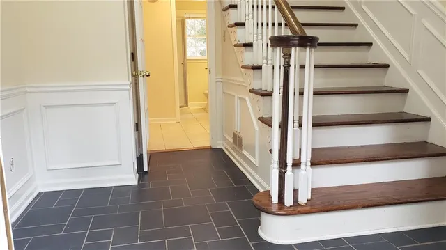 an empty room with wooden floor and a fireplace