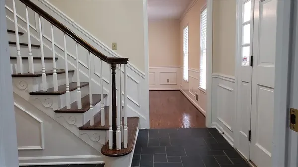 a view of entryway and hall with wooden floor