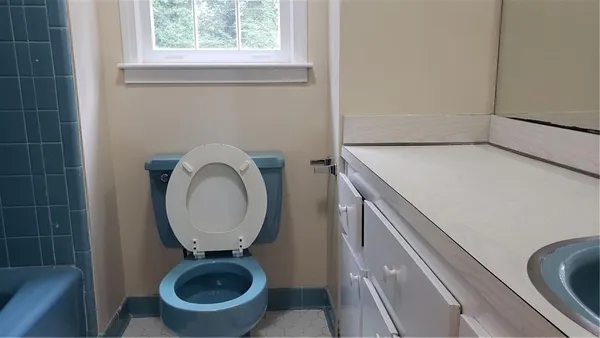 a bathroom with a toilet and a sink