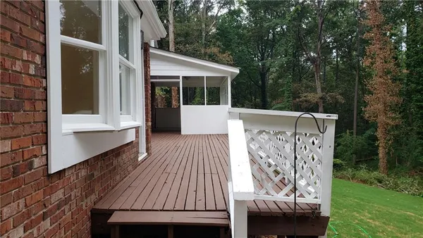 a view of backyard with a deck and furniture