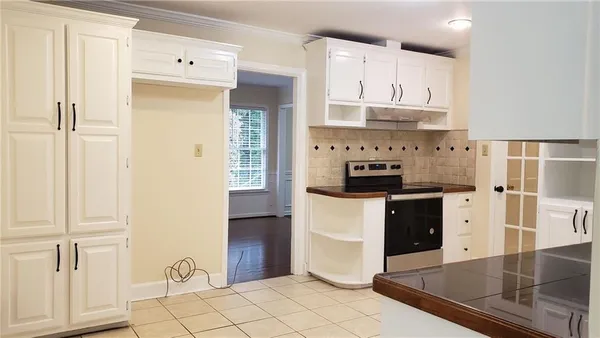 a kitchen with stainless steel appliances a refrigerator sink and cabinets