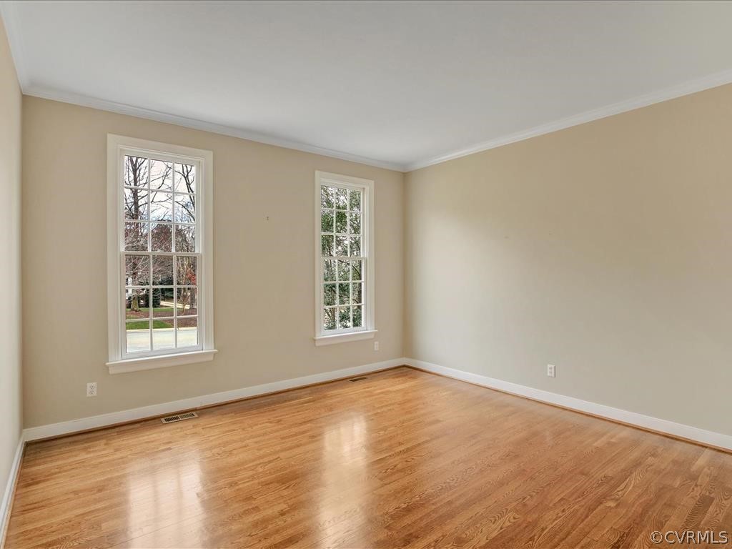 2010 Corner Rock Road Midlothian, VA 23113 - Photo 6 of 27 a view of an empty room with wooden floor and a window