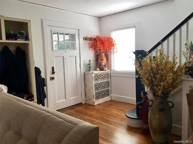 a livingroom with wooden floor and a flat screen tv
