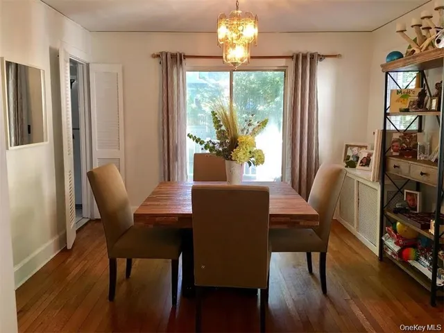 a view of a dining room with furniture a chandelier and wooden floor