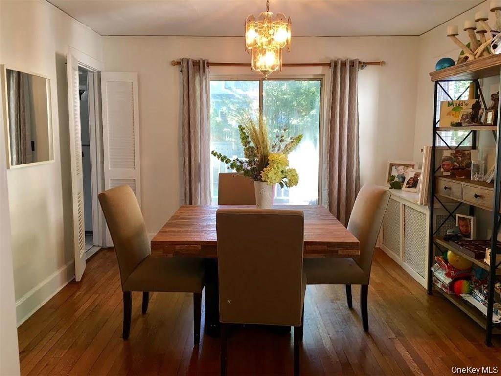 86 Brown Road Scarsdale, NY 10583 - Photo 6 of 17 a view of a dining room with furniture a chandelier and wooden floor