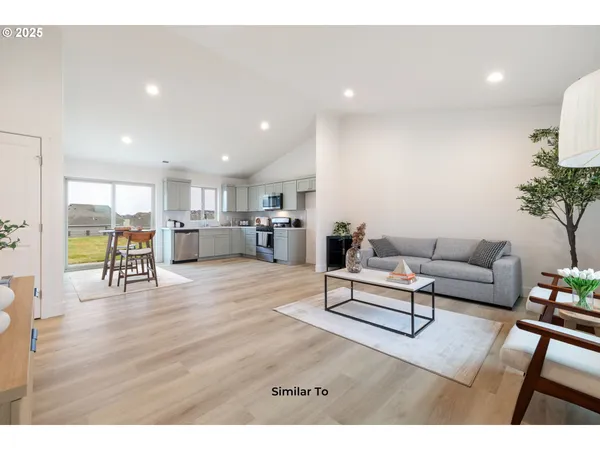 a living room with furniture and a table with wooden floor
