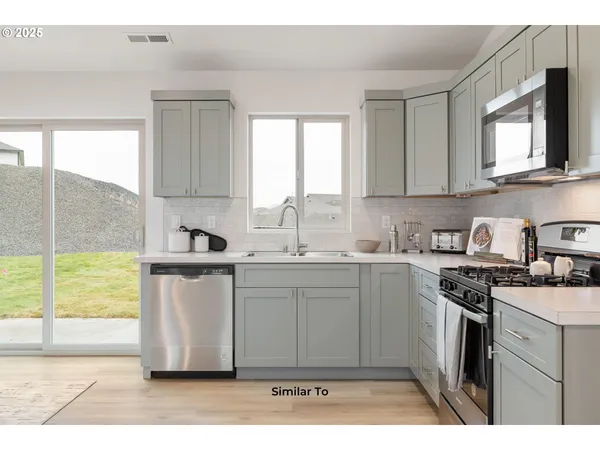 a kitchen with a sink cabinets and window