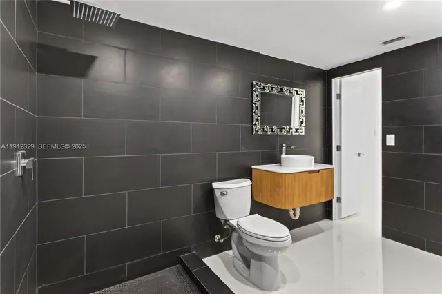 a bathroom with a toilet and shower