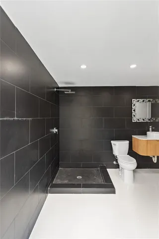 a bathroom with a toilet and a shower