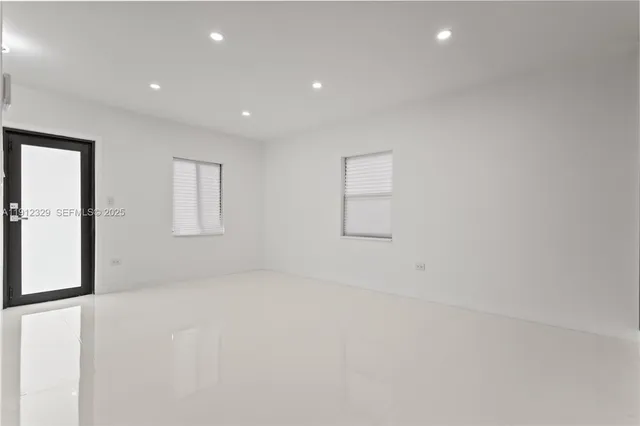 an empty room with windows and closet