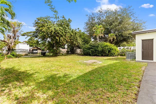a view of yard with swimming pool and green space