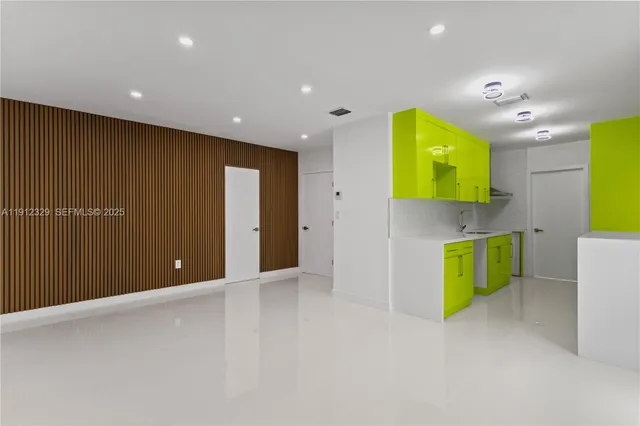 a view of an empty room with a window and fire place