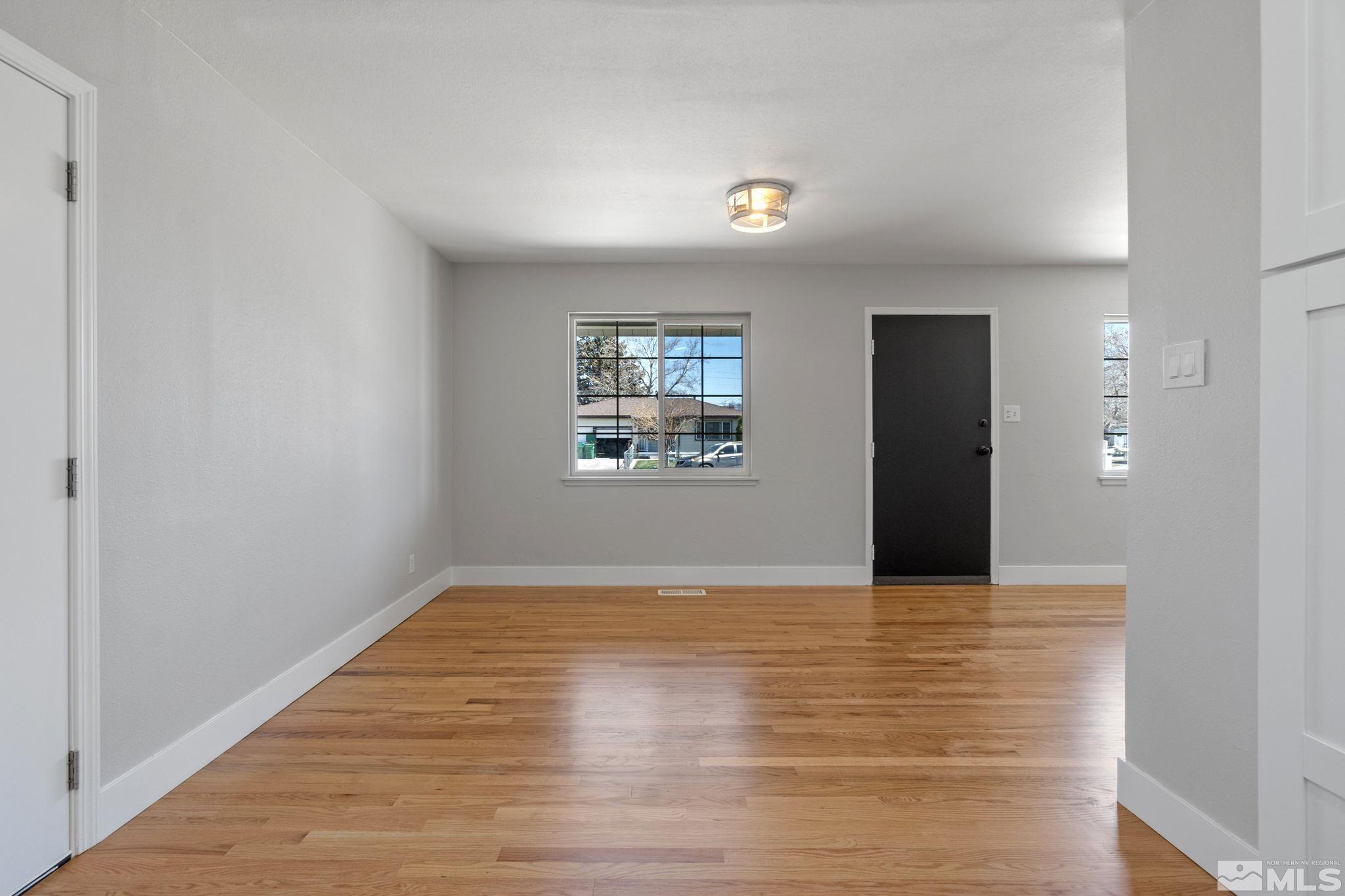 1685 Clemson Road Reno, NV 89502 - Photo 11 of 32 a view of an empty room with wooden floor and a window