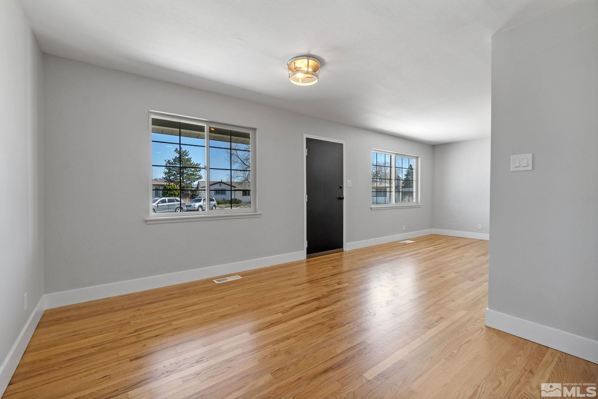 1685 Clemson Road Reno, NV 89502 - Photo 12 of 32 a view of livingroom with window and wooden floor