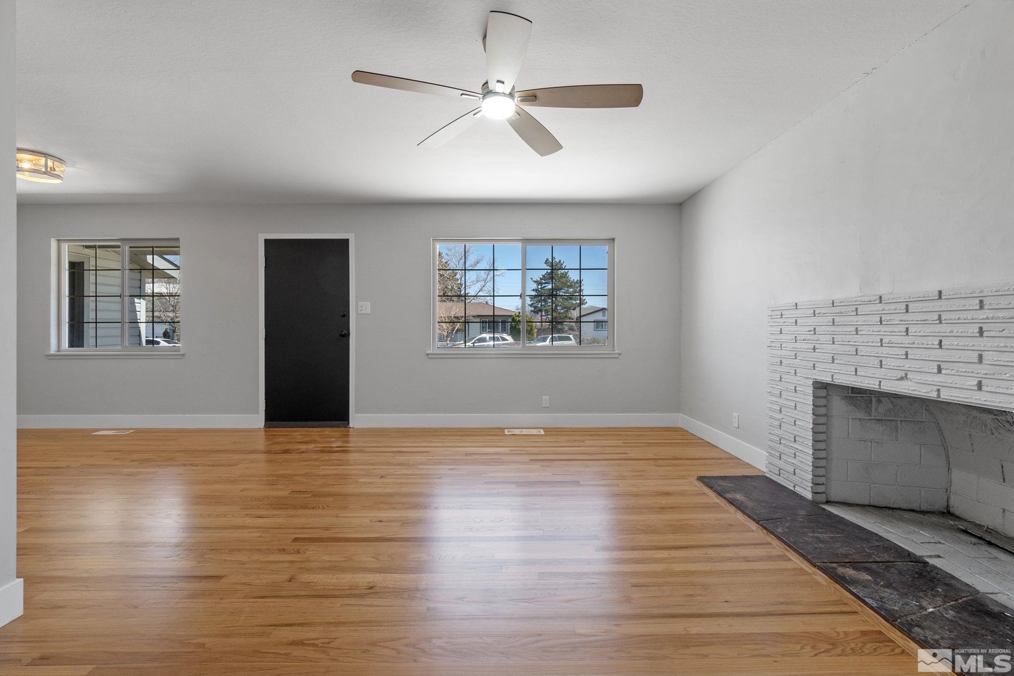 1685 Clemson Road Reno, NV 89502 - Photo 13 of 32 a view of an empty room with a fireplace and a window