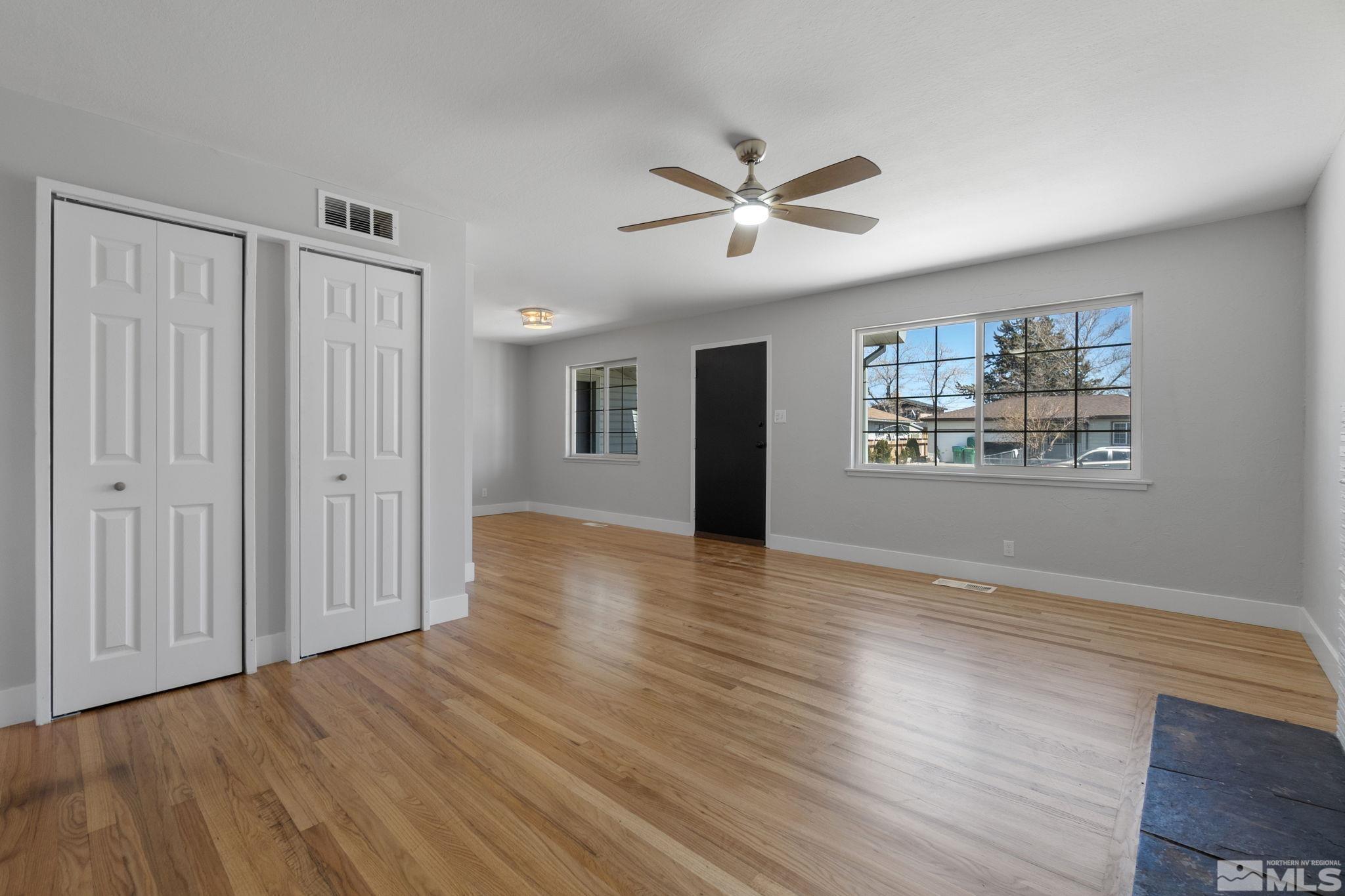 1685 Clemson Road Reno, NV 89502 - Photo 15 of 32 a view of a livingroom with wooden floor and a ceiling fan
