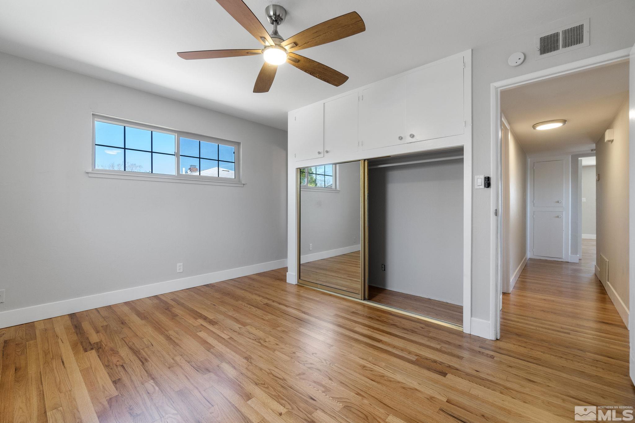 1685 Clemson Road Reno, NV 89502 - Photo 16 of 32 an empty room with wooden floor and door