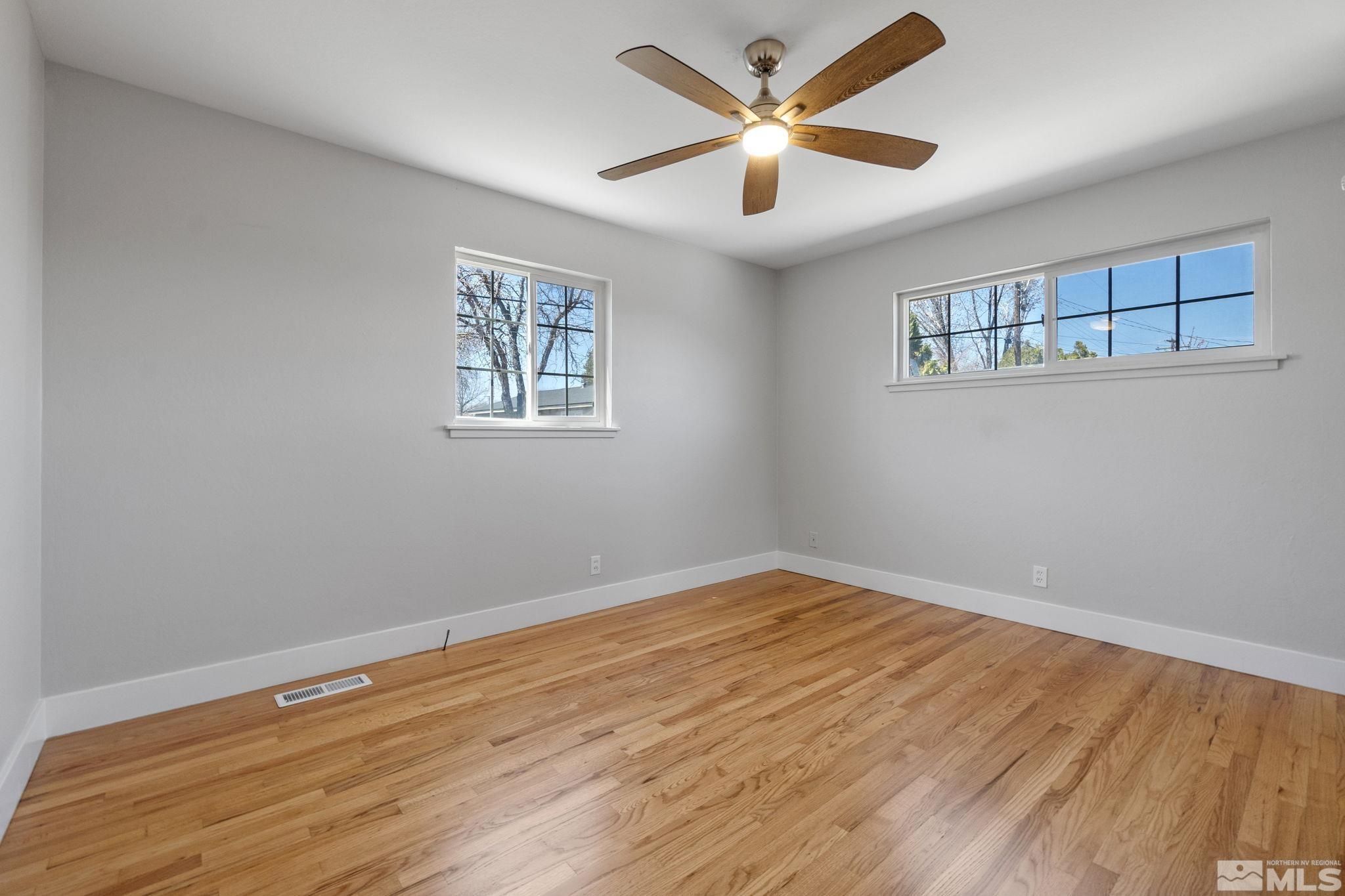 1685 Clemson Road Reno, NV 89502 - Photo 17 of 32 a view of an empty room with window and wooden floor