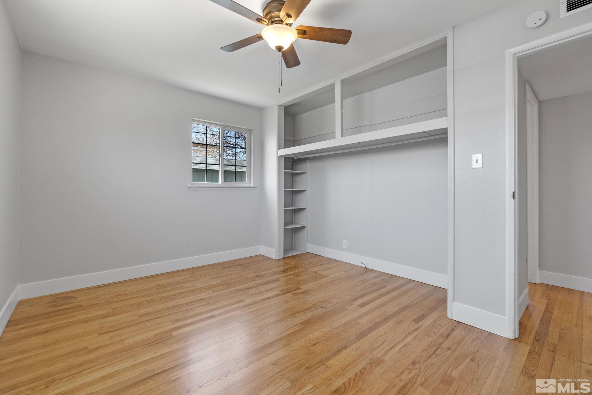 1685 Clemson Road Reno, NV 89502 - Photo 19 of 32 a view of an empty room with a window and wooden floor