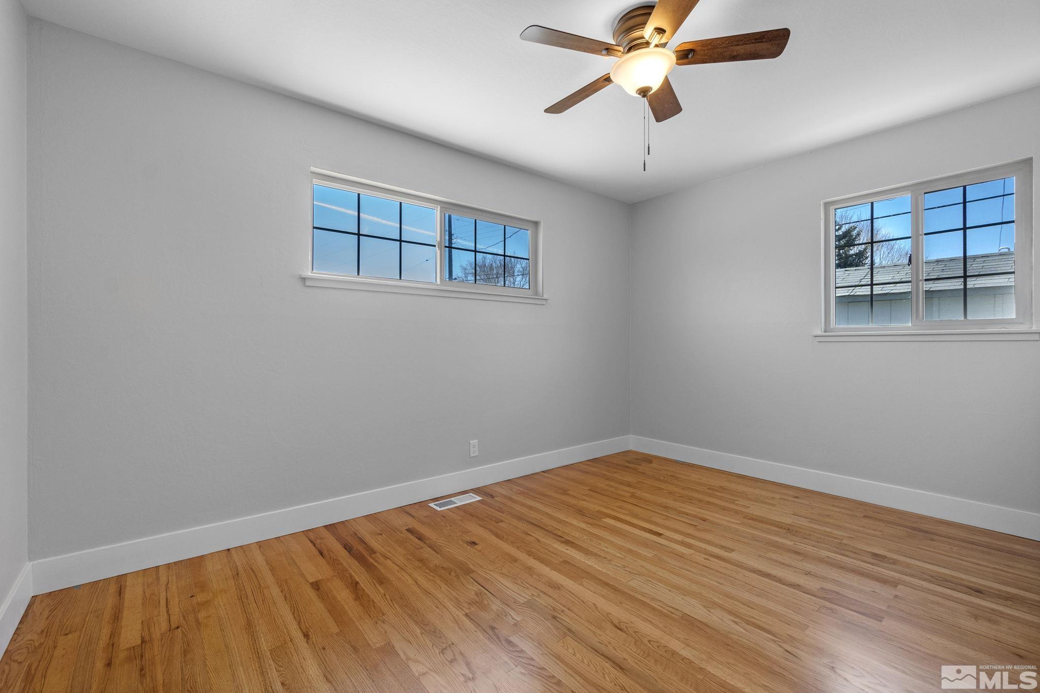 1685 Clemson Road Reno, NV 89502 - Photo 20 of 32 a view of a room with wooden floor and chandelier fan