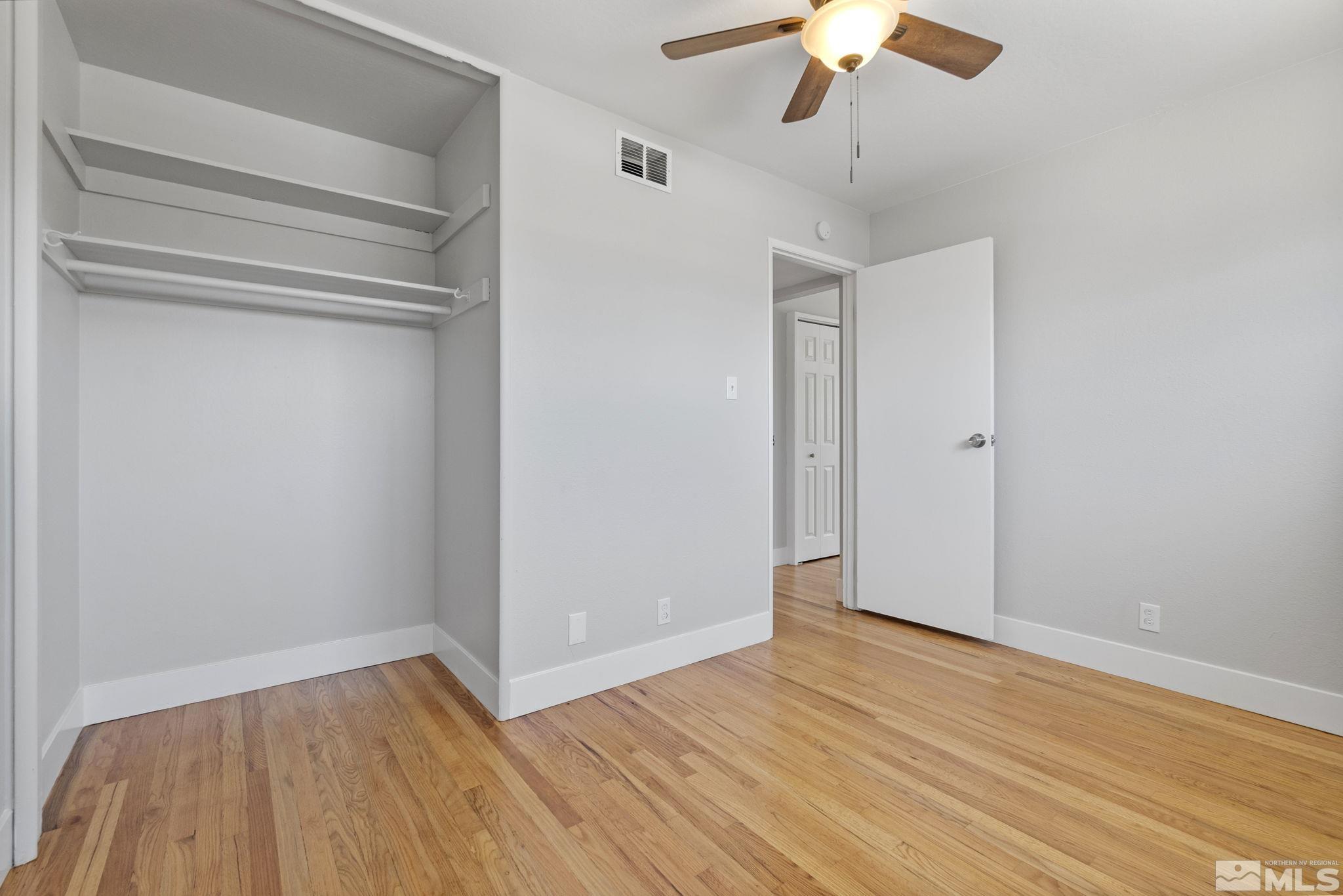 1685 Clemson Road Reno, NV 89502 - Photo 22 of 32 a view of empty room with wooden floor and fan