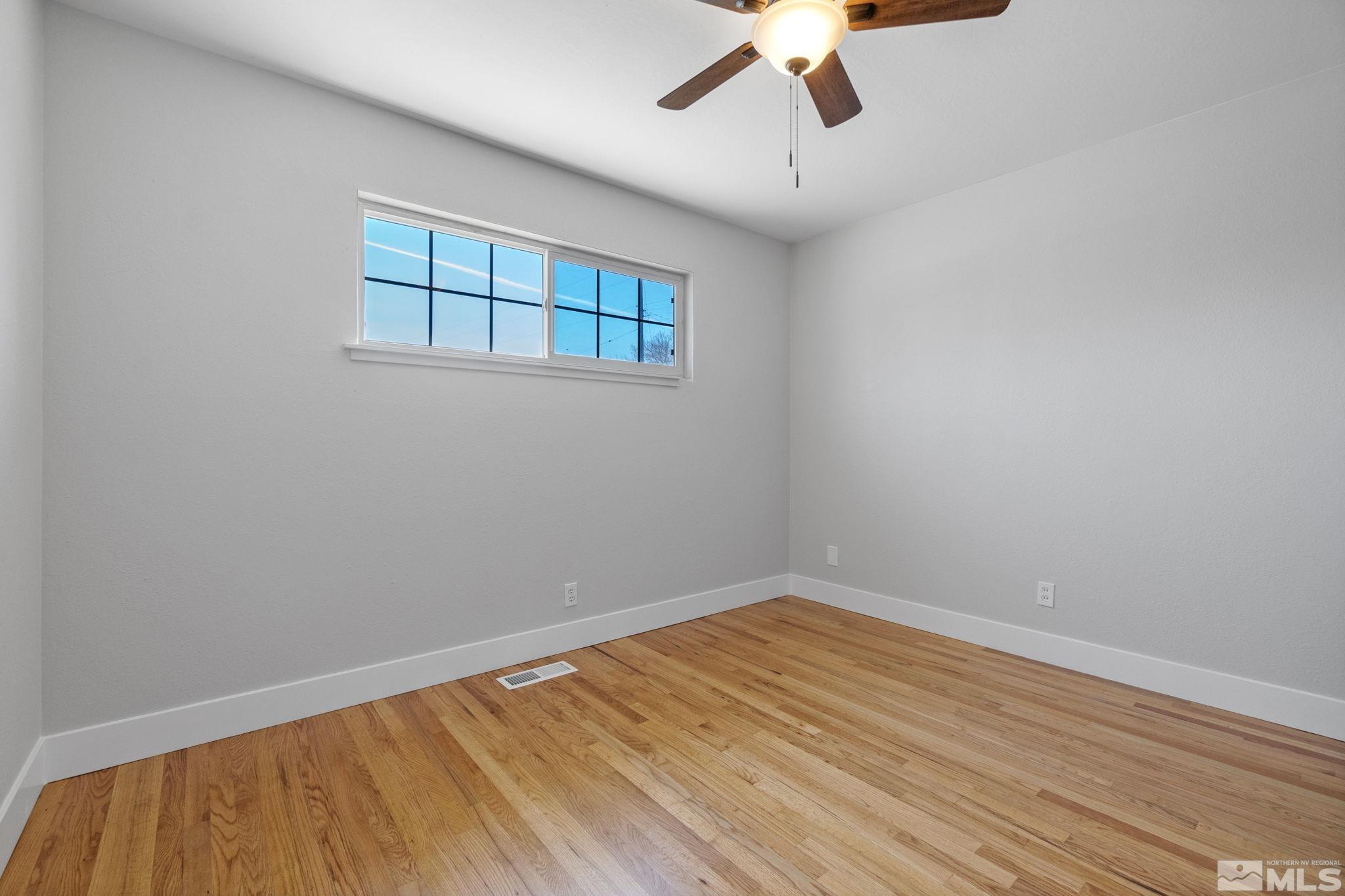 1685 Clemson Road Reno, NV 89502 - Photo 23 of 32 a view of empty room with wooden floor and fan
