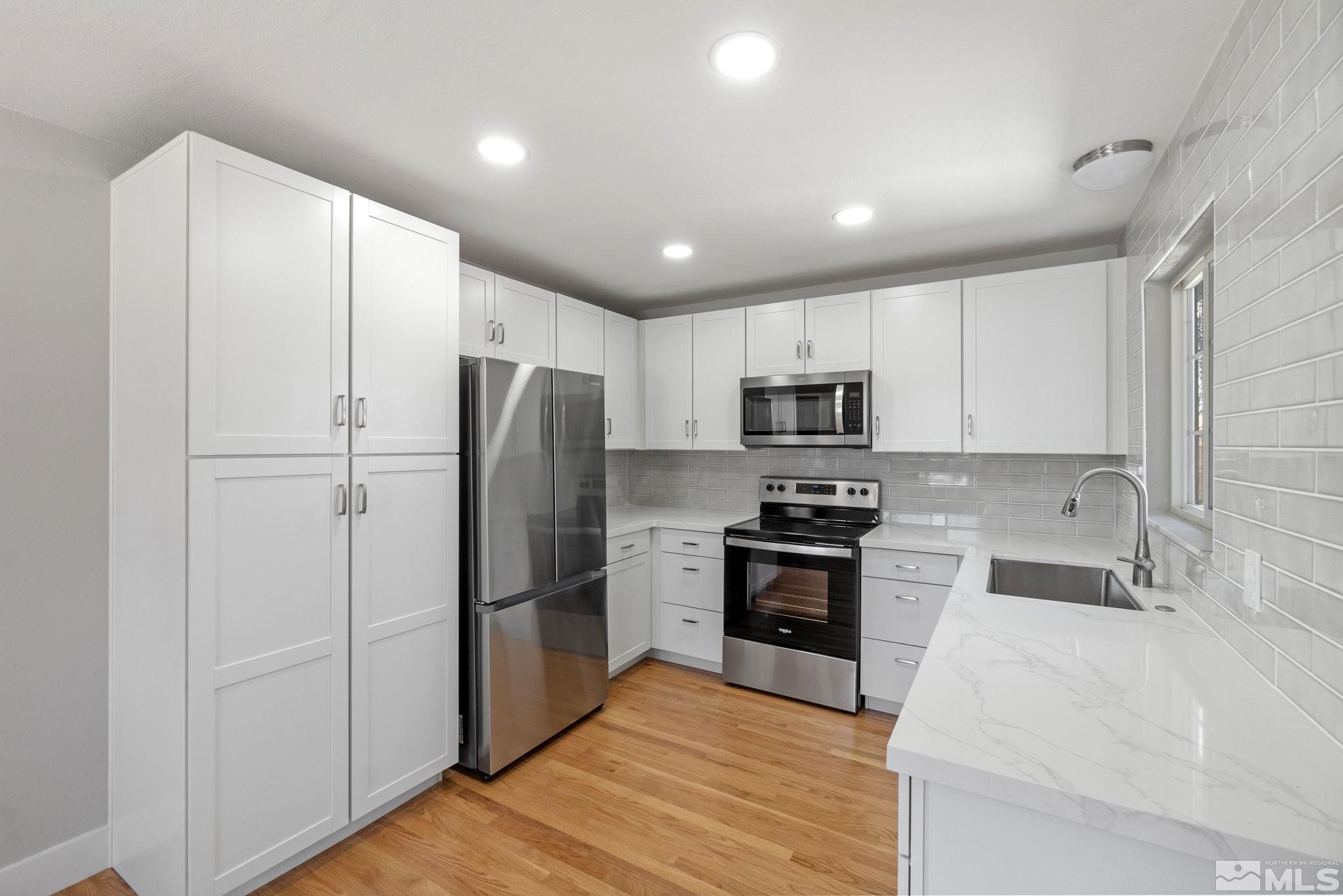 1685 Clemson Road Reno, NV 89502 - Photo 4 of 32 a kitchen with stainless steel appliances granite countertop a refrigerator sink and stove