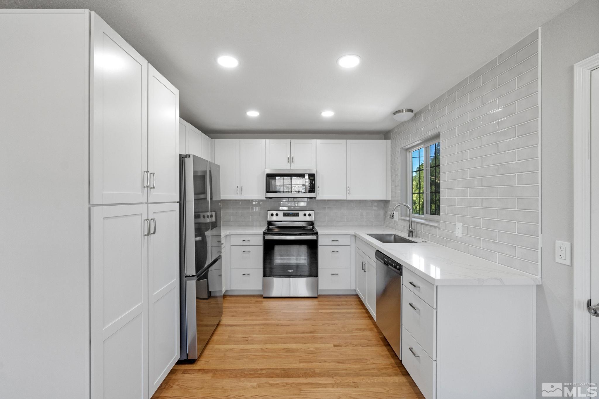 1685 Clemson Road Reno, NV 89502 - Photo 5 of 32 a large kitchen with stainless steel appliances granite countertop a refrigerator and a sink